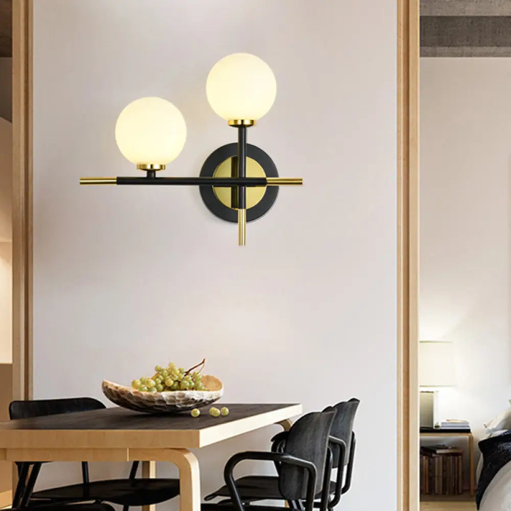 DecorBites™ DecorBites™ Modern Milk Glass Orb Sconce Wall Light - 2 Lights, Black and Brass Cross Design