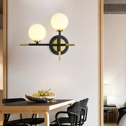 DecorBites™ DecorBites™ Modern Milk Glass Orb Sconce Wall Light - 2 Lights, Black and Brass Cross Design