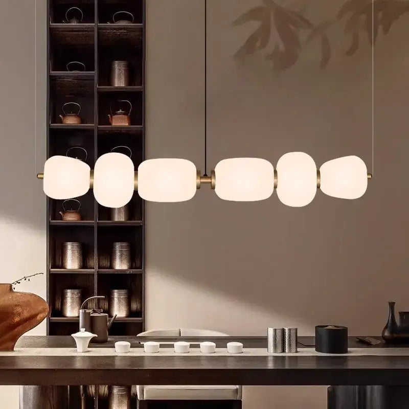 Modern milky white glass ball pendant light with five frosted glass orbs and brass accents for dining room decorbites glass ball