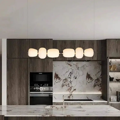 Modern milky white glass ball pendant light with five frosted glass shades on a sleek metal frame for dining room decorbites glass ball pendant light
