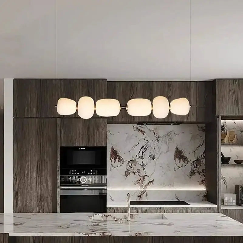 Modern milky white glass ball pendant light with five frosted glass shades on a sleek metal frame for dining room decorbites glass ball pendant light