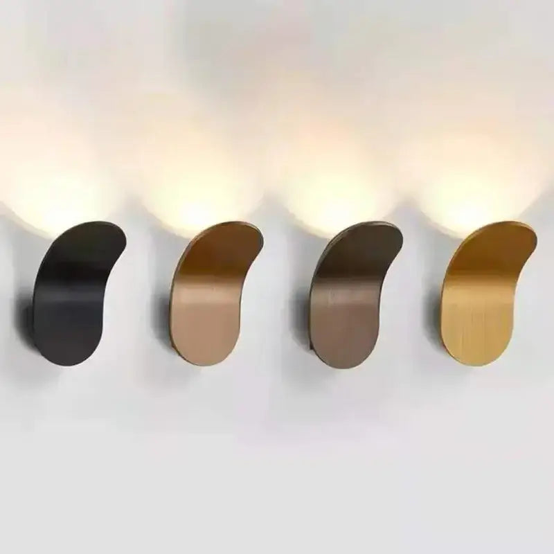 Modern minimalist adjustable cob led wall light bedroom sconce in sleek black and gold curved metal finishes by decorbites