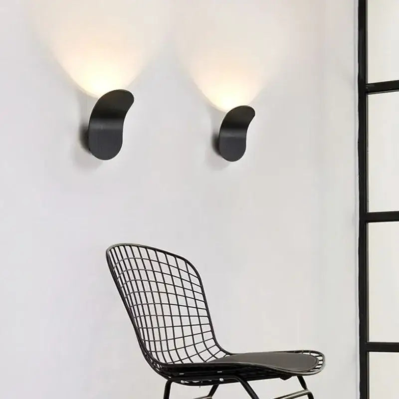 Black minimalist wall light with sleek curved design featuring decorbites adjustable cob led for modern bedroom sconce decor