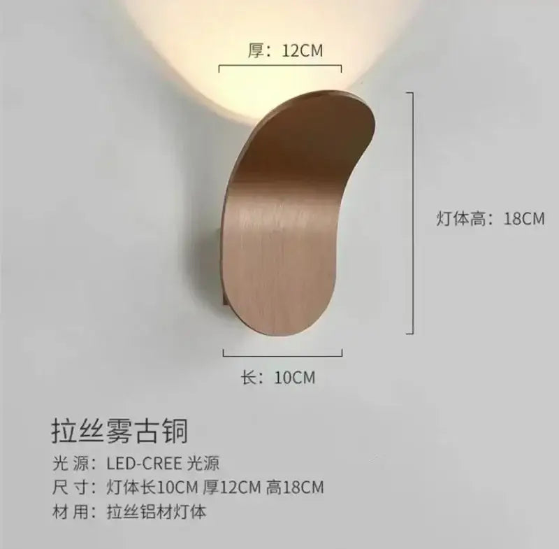 A sleek brushed antique copper decorbites adjustable cob led wall light with modern curved design for bedroom decor