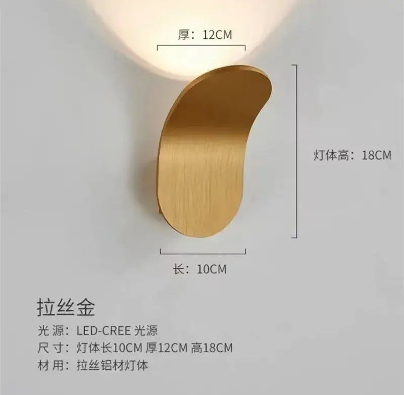A sleek brushed gold modern minimalist adjustable led wall light with crescent design for bedroom use