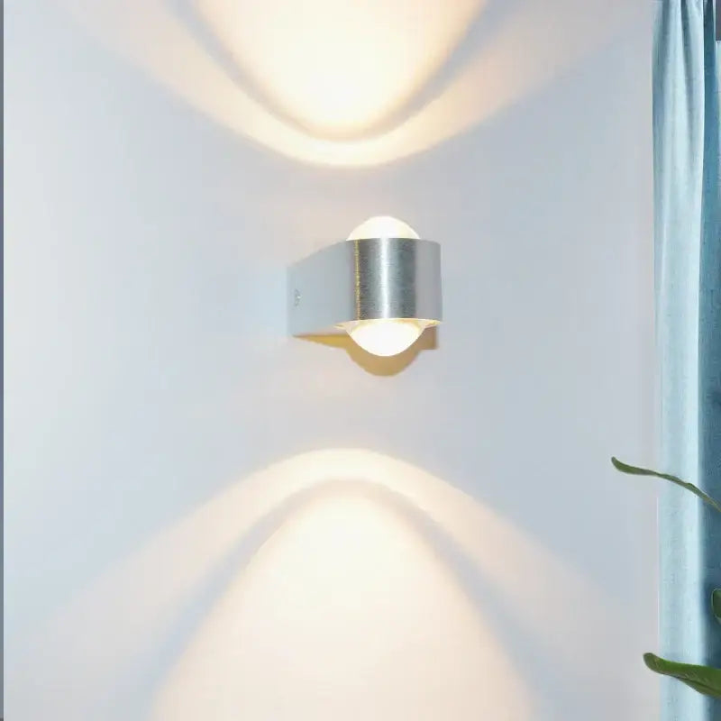 Modern minimalist silver-toned led wall lamp with sleek cylindrical aluminum sconce for bedroom decor lighting