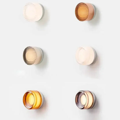 Six modern minimalist amber jelly led wall sconces with ribbed glass shades in translucent amber gold and cream hues for bedroom decorbites