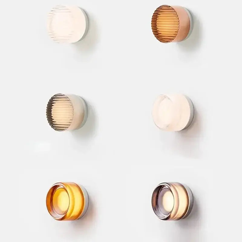 Six modern minimalist amber jelly led wall sconces with ribbed glass shades in translucent amber gold and cream hues for bedroom decorbites