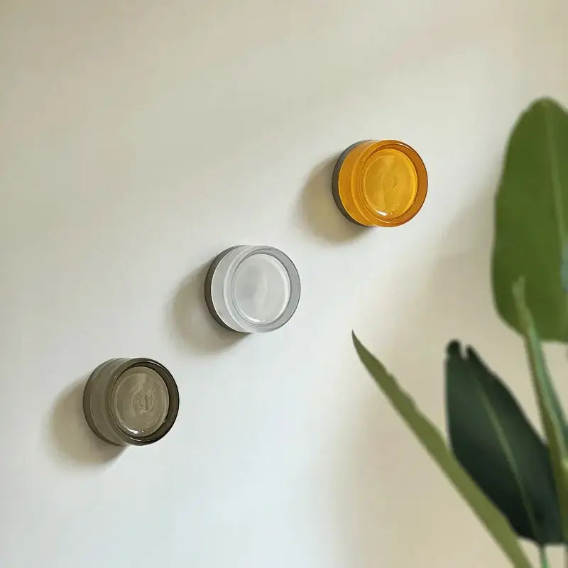 Modern minimalist wall sconce with circular amber, cream, and smoky gray glass holders for bedroom decorbites amber jelly led