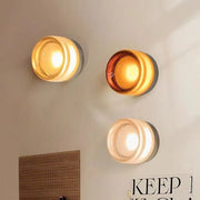 Three modern minimalist amber and cream glass wall sconces featuring decorbites amber jelly led for bedroom lighting