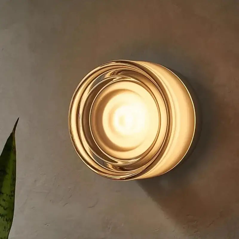 Modern minimalist amber and cream glass wall sconce with warm brass concentric rings featuring decorbites amber jelly led light