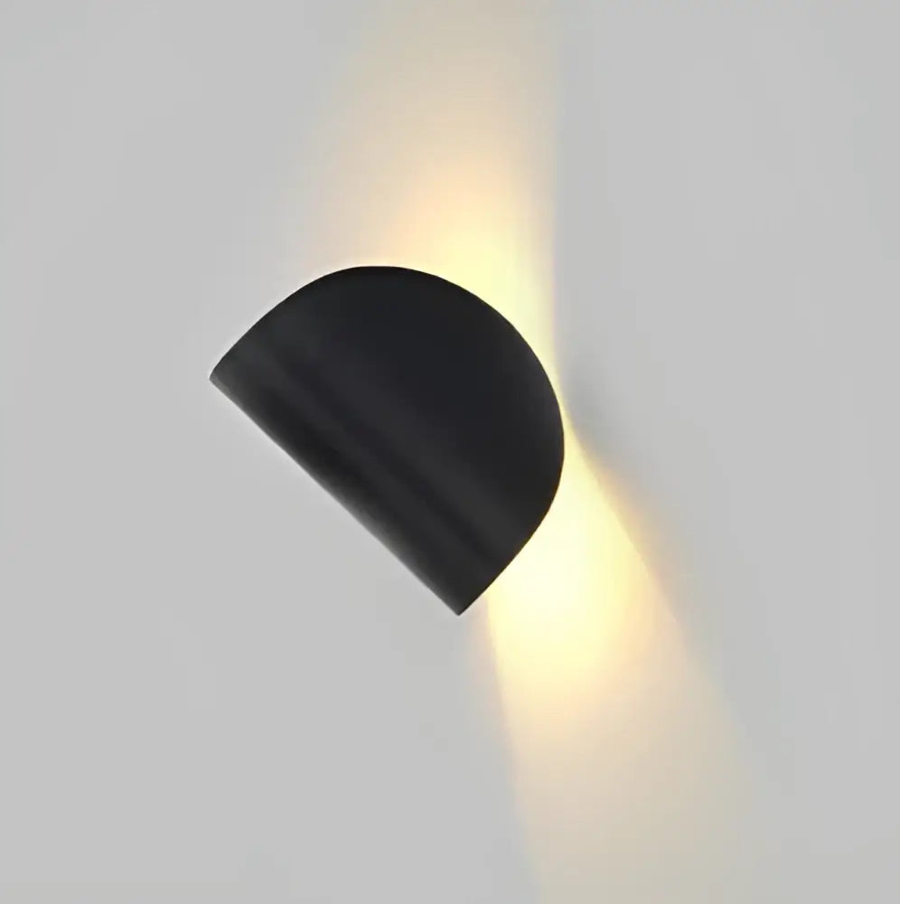 Modern minimalist black semi-circular wall lamp with matte finish emitting warm light decorbites art decor rotating