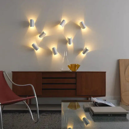 White cylindrical modern minimalist wall lamp with warm focused lighting for decorbites art decor rotating bedroom sconce