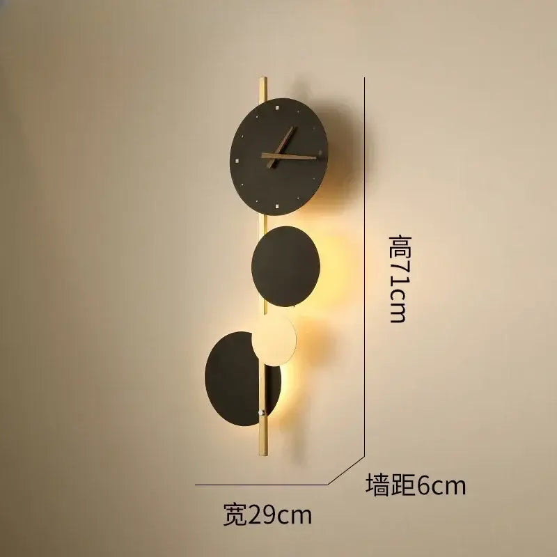 Modern black circular led wall clock sconce with gold-toned accents and integrated lighting for living room home decor