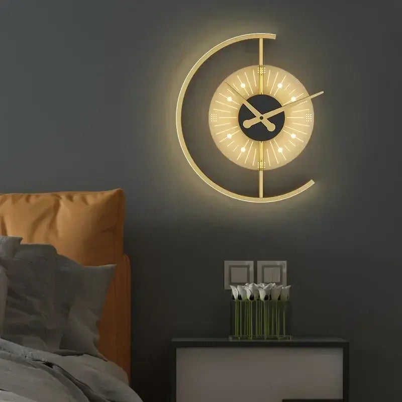 Modern gold-toned led wall clock sconce with glowing circular design and illuminated hour markers for home decor