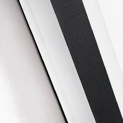Black textured adhesive strip on the back side of a modern minimalist black aluminum waterproof led outdoor wall lamp