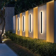 Modern minimalist black aluminum waterproof led outdoor wall lamp with sleek frames and warm yellow backlighting