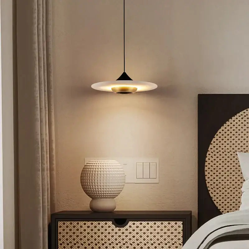 Modern minimalist black cloud stone pendant lamp with sleek conical stem, frosted disc shade, and gold accent ring