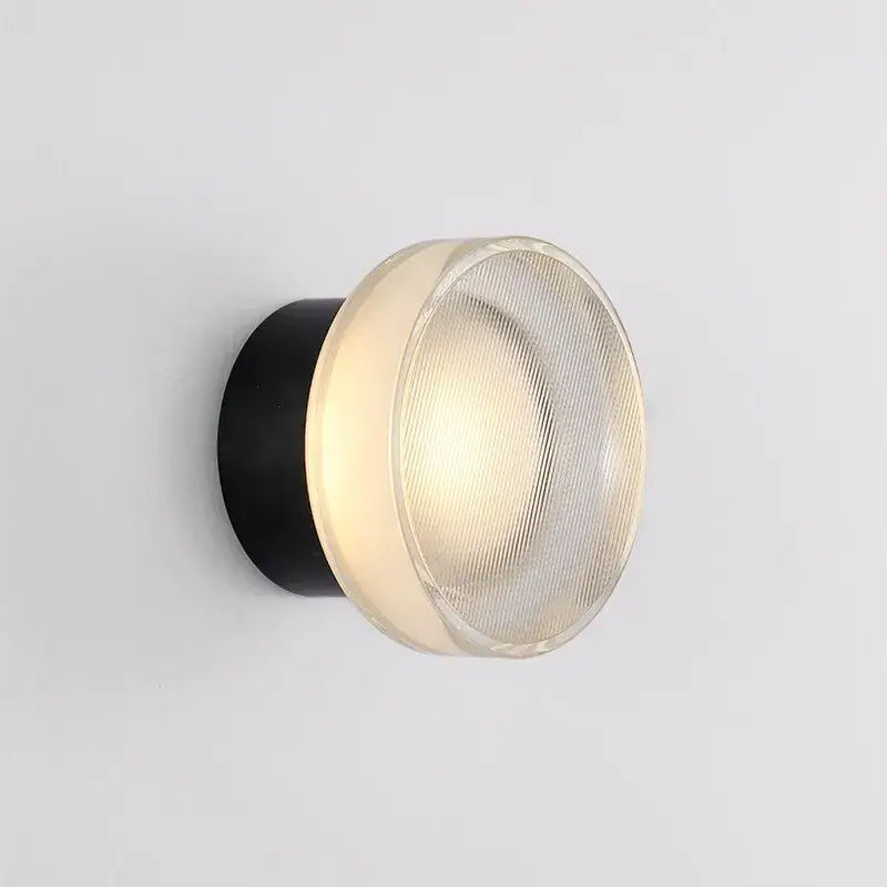 Modern minimalist black elegant glass led wall sconce with frosted ribbed diffuser emitting warm light for decorbites elegant glass decor