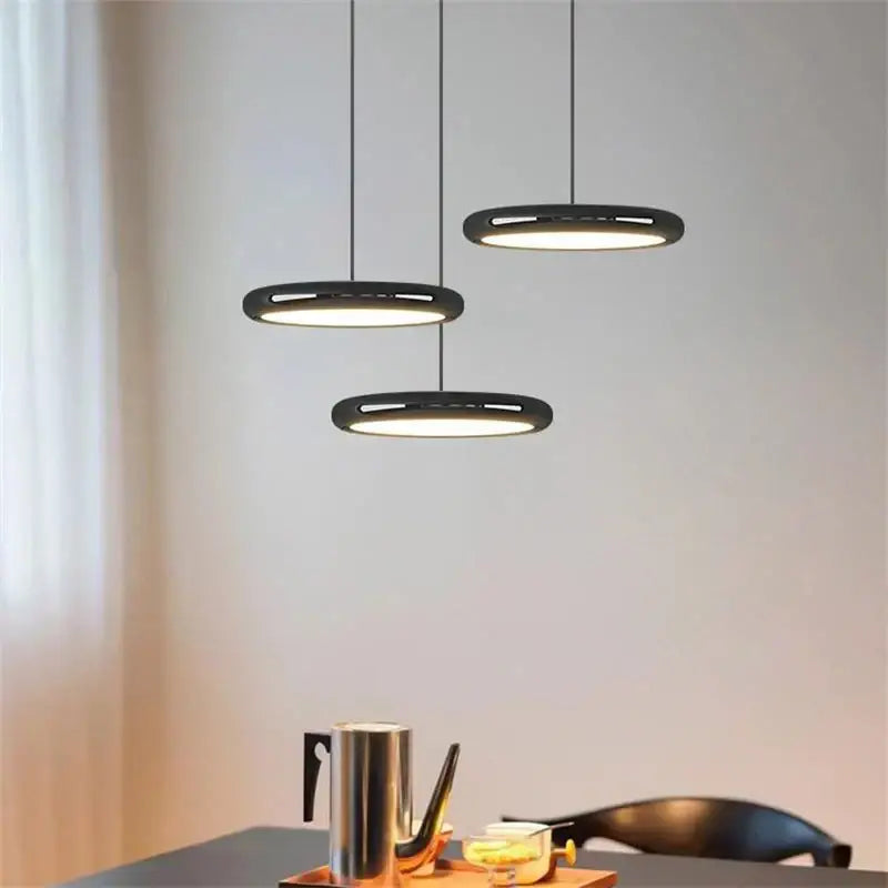 Modern minimalist black finish pendant lights with sleek circular design and warm ambient glow for dining room decorbites black finish