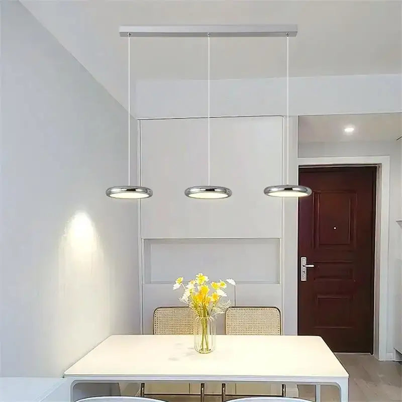 Modern minimalist pendant lights with black finish featuring three circular chrome lamps for dining room decorbites black finish