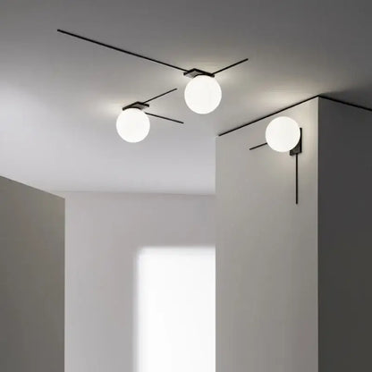Minimalist black metal glass ball wall lights with three white globe glass balls for modern bedroom lighting