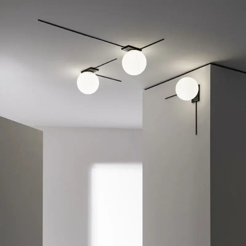 Minimalist black metal glass ball wall lights with three white globe glass balls for modern bedroom lighting