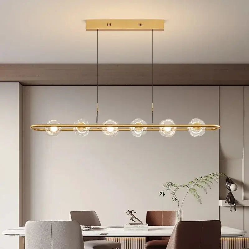 Modern minimalist pendant light with five clear glass led chandelier globes in gold-toned led chandelier pendant design