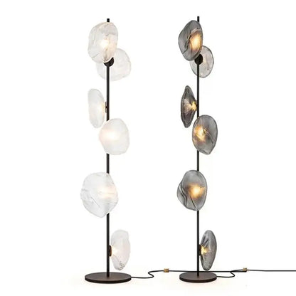 Two modern minimalist floor lamps with black metal poles and glass shade led orbs for stylish home decor
