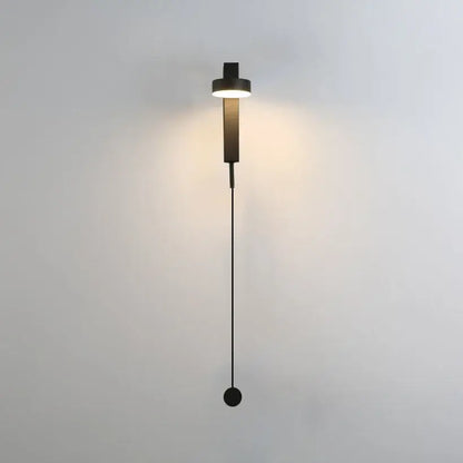 Modern minimalist black and gold t style wall light sconce with cylindrical light head and hanging spherical base for bedroom