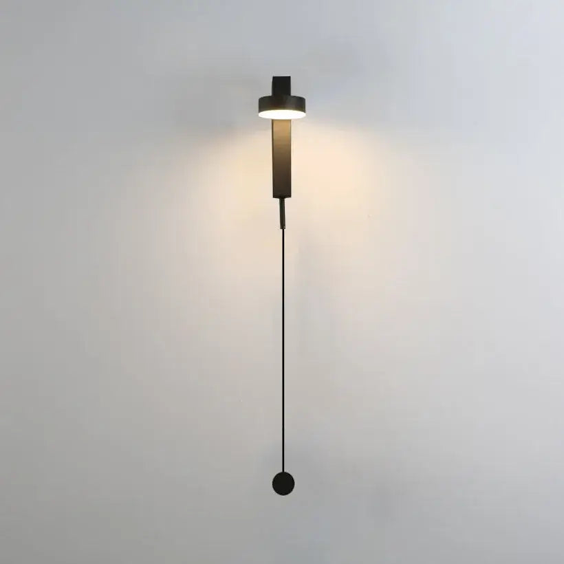 Modern minimalist black and gold t style wall light sconce with cylindrical light head and hanging spherical base for bedroom