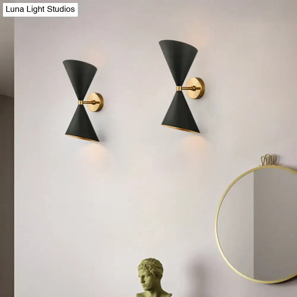 Modern minimalist black and gold wall light fixture with conical design and metal accents for bedroom sconce use
