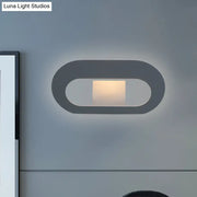 Modern minimalist black and grey oval shade wall lamp with sleek design and soft ambient lighting for bedroom use
