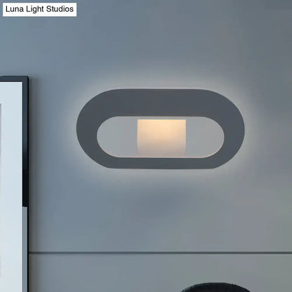 Modern minimalist black and grey oval shade wall lamp with sleek design and soft ambient lighting for bedroom use