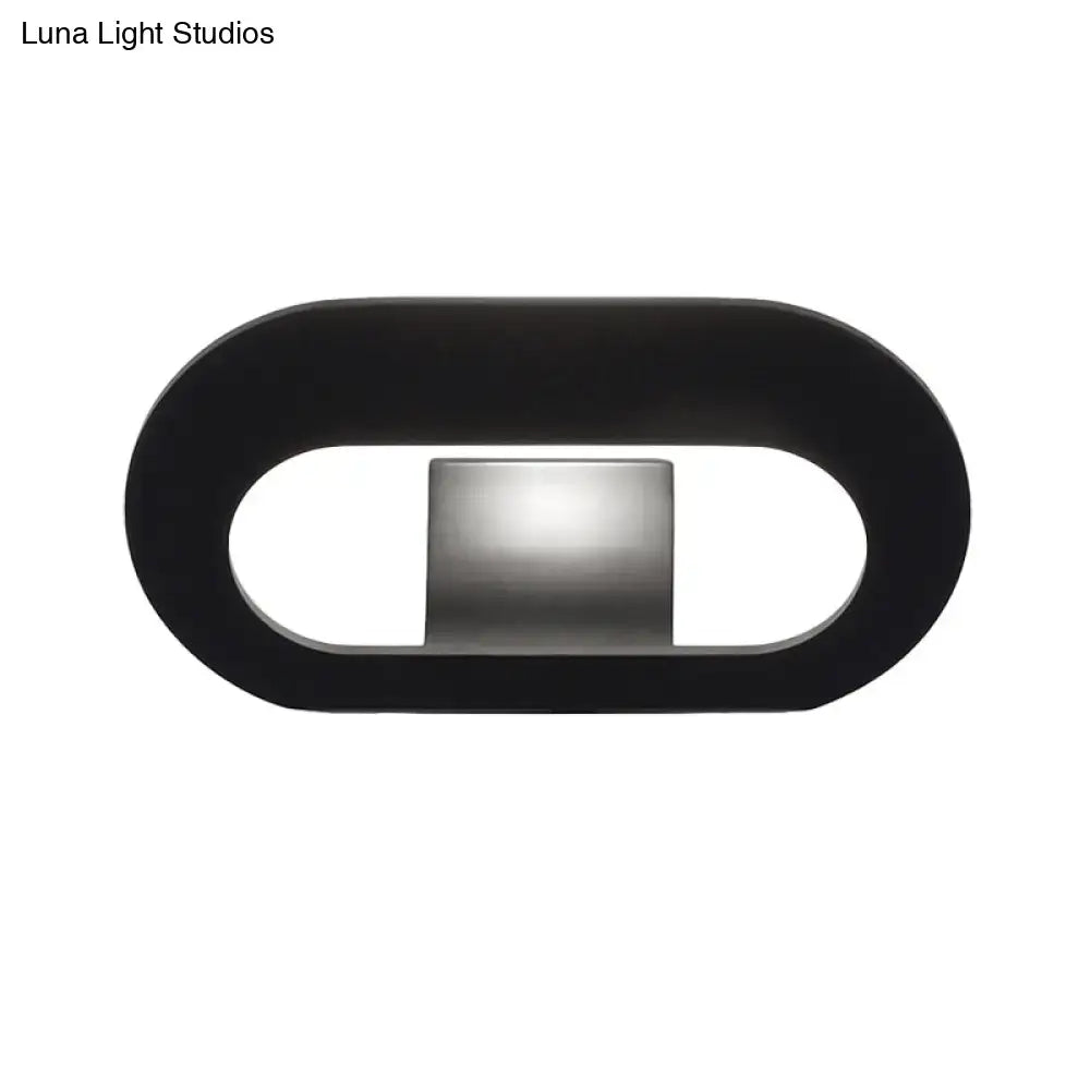 Modern minimalist black wall lamp with oval shade and central metallic panel for bedroom lighting with max bulb wattage