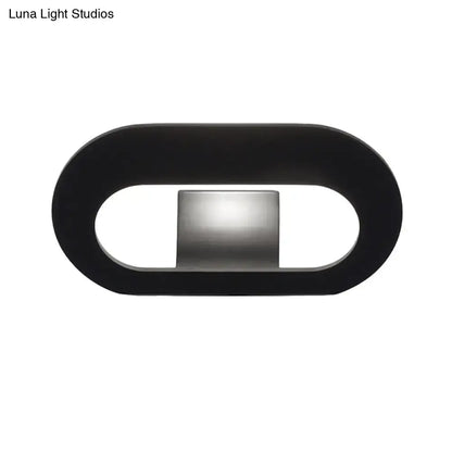 Modern minimalist black wall lamp with oval shade and central metallic panel for bedroom lighting with max bulb wattage