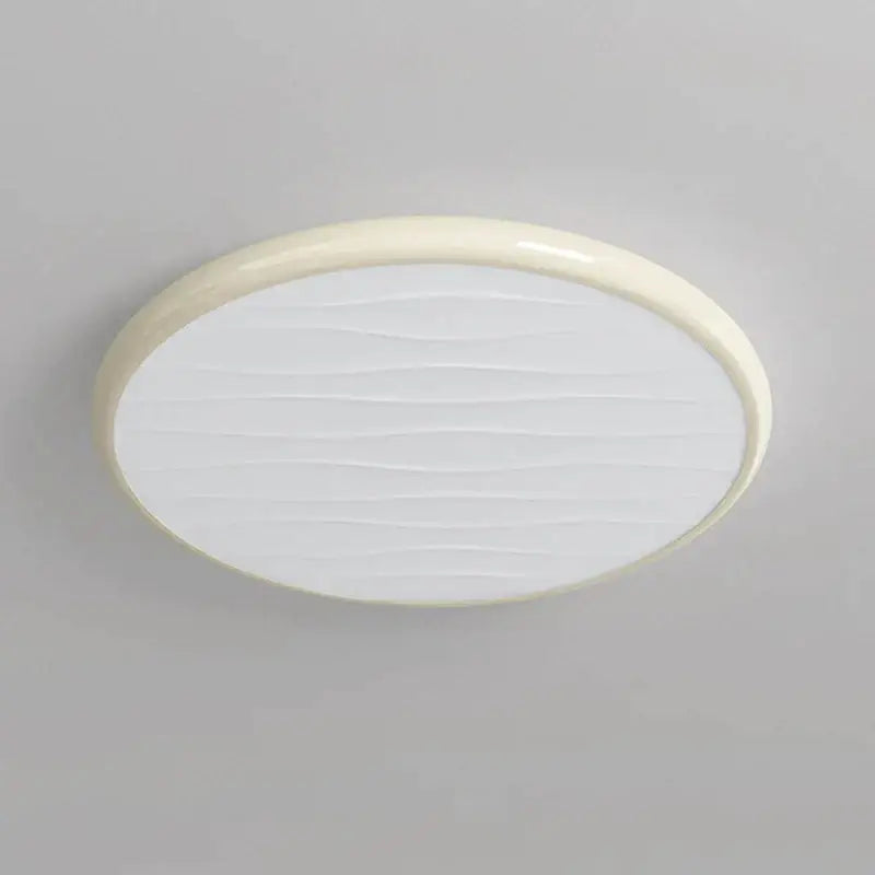 Modern minimalist cream-colored oval decorbites led ceiling light with glossy frame and white diffuser for bedroom use