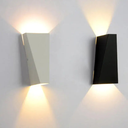 Modern minimalist black led wall lamp with matte white and black geometric design providing warm ambient lighting