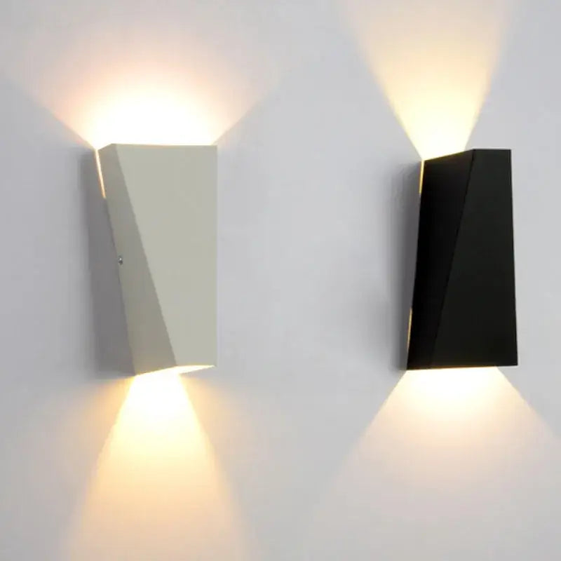 Modern minimalist black led wall lamp with matte white and black geometric design providing warm ambient lighting