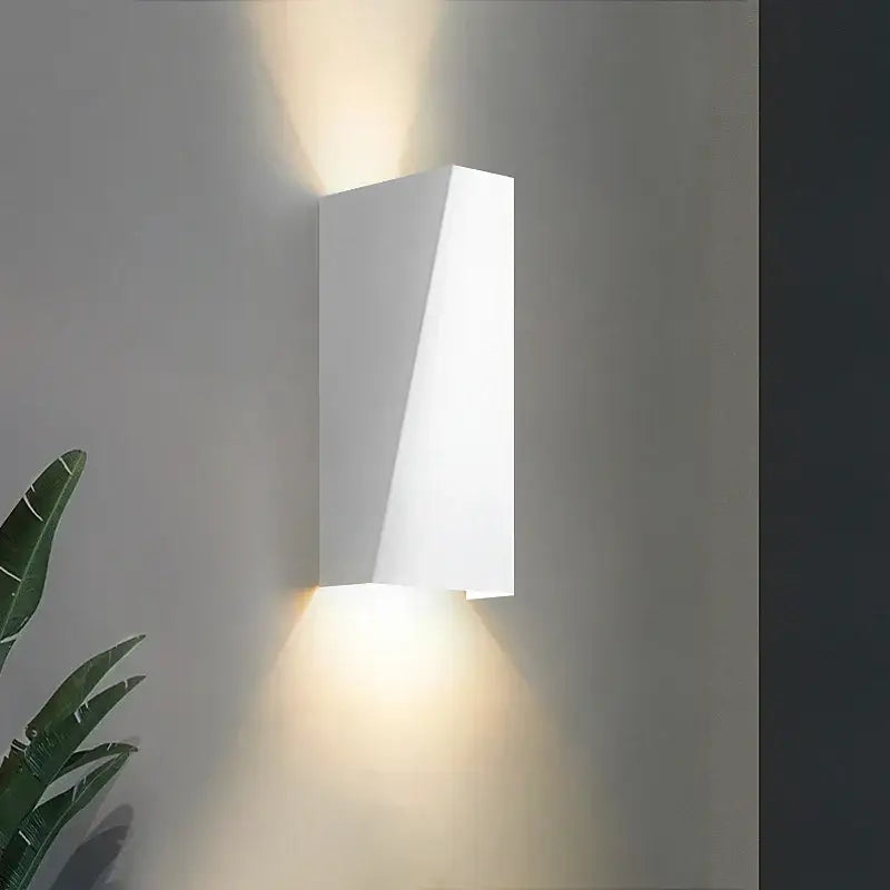 Modern minimalist black led wall lamp with sleek rectangular wall sconce casting warm light for bedroom reading