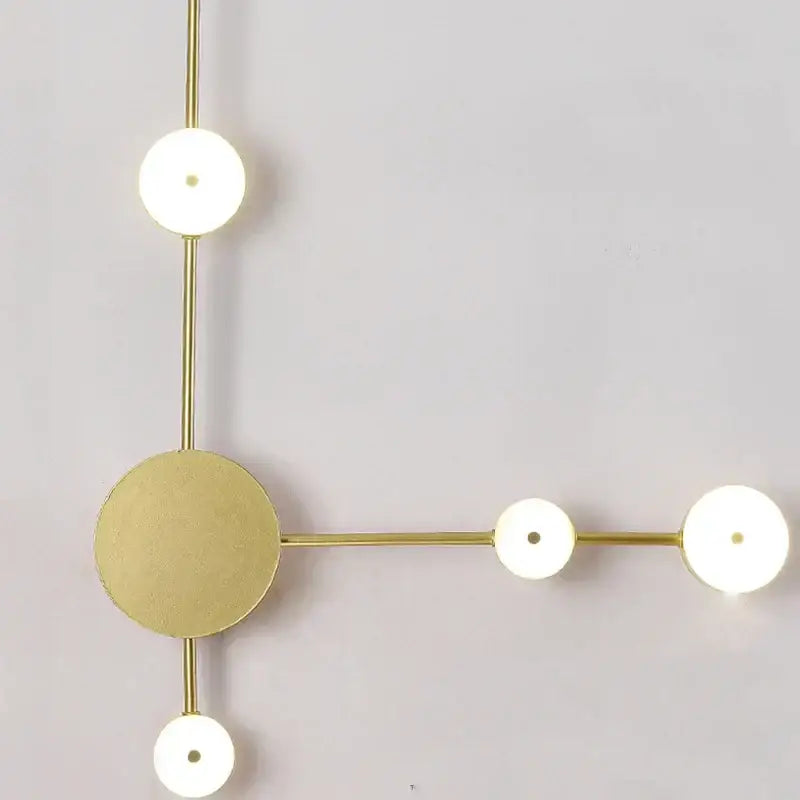 Modern gold-toned wall lamp with circular LED fixtures and minimalist geometric design for living space illumination