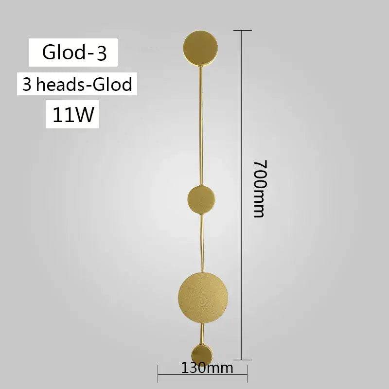 Gold-colored minimalist modern led wall lamp with three circular heads on a slender rod for living room use