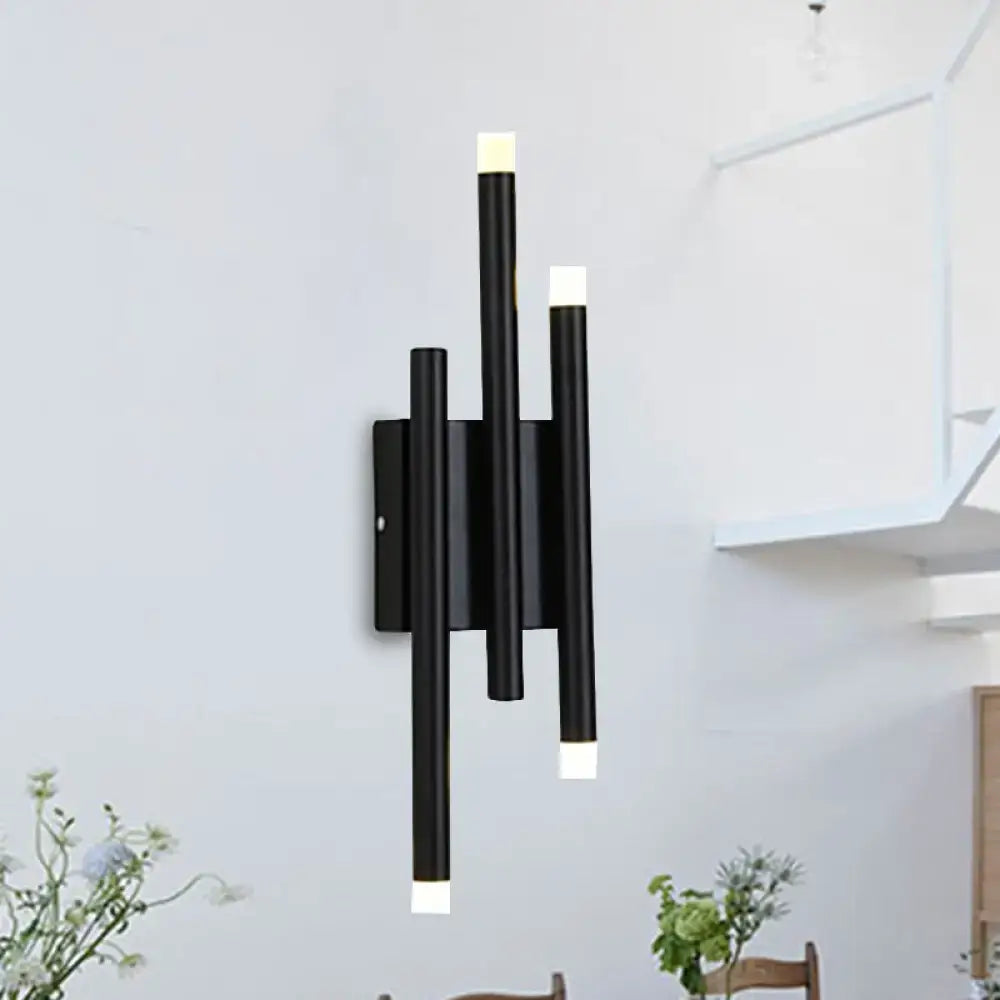 Modern minimalist black led wall lamp with three vertical cylindrical arms and white light caps offering light options