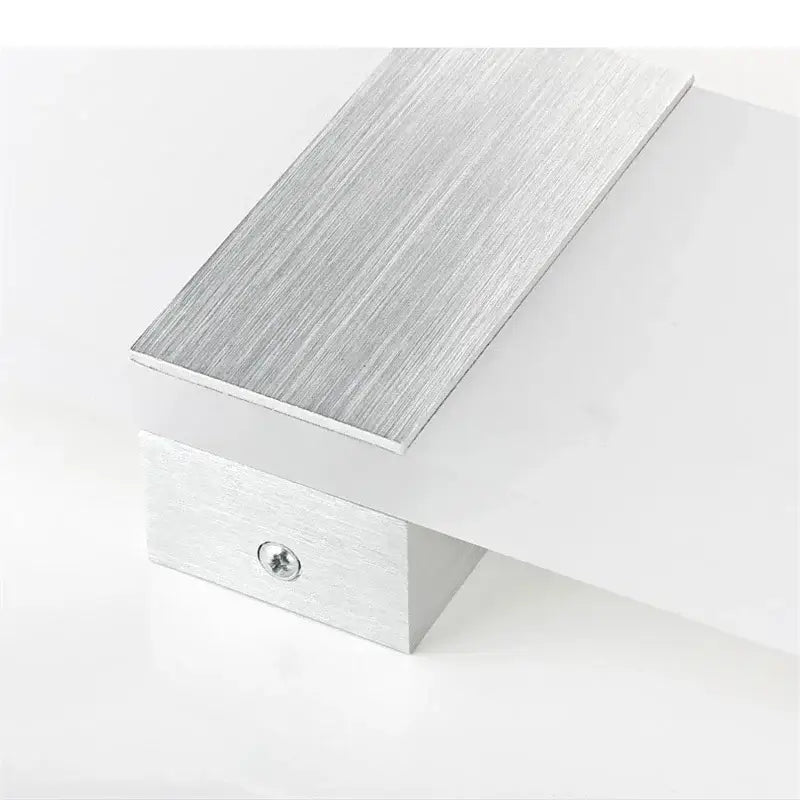 Silver brushed aluminum door stop with rectangular design and visible screw base for modern minimalist led wall light decorbites wall light