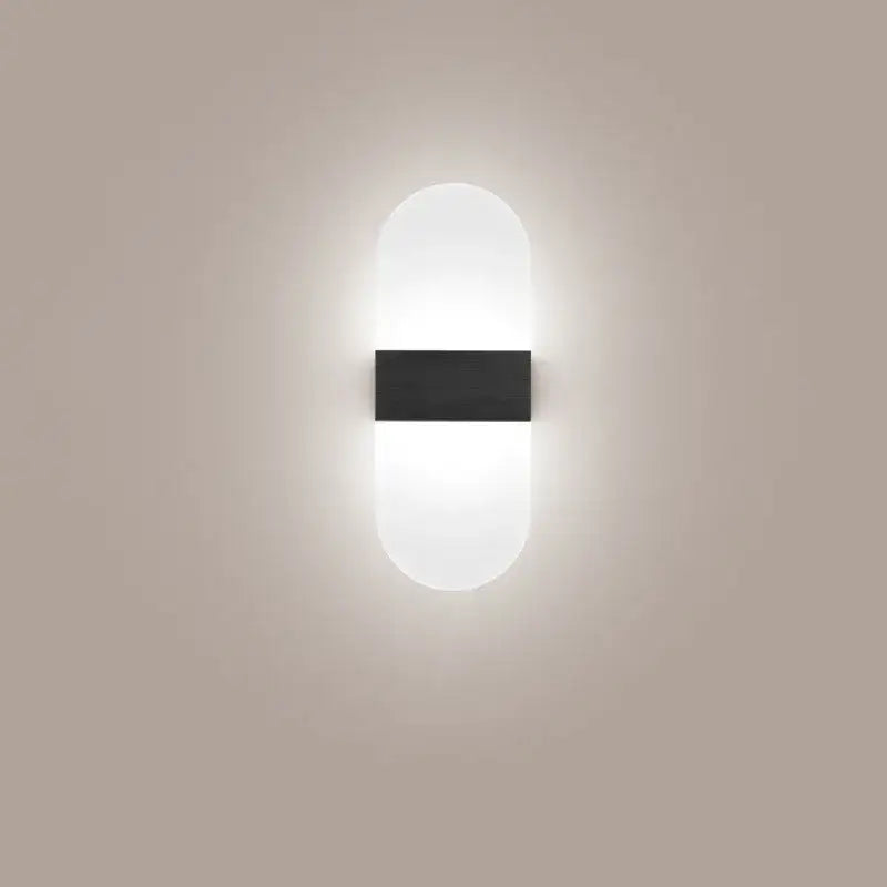 Modern minimalist black led wall light with sleek oval shape, frosted diffuser, and matte black panel for bedroom decorbites led wall