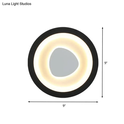 Modern minimalist black wall light with acrylic shade featuring a circular led ring and gray irregular center for bedroom