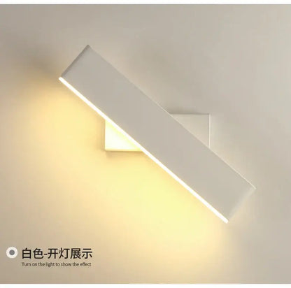 Modern minimalist black rotate wall lamp with sleek white rectangular sconce emitting warm ambient light for bedside reading