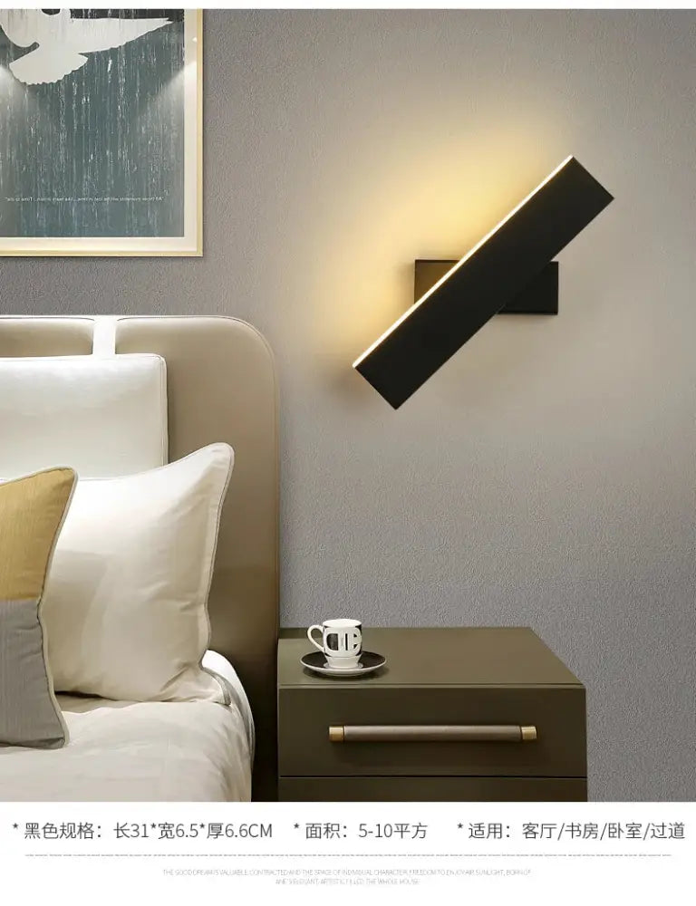 Modern minimalist black wall lamp with a sleek angular design and degree rotate feature for bedside reading
