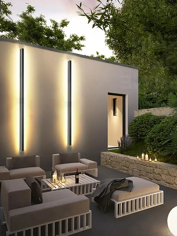 Modern minimalist outdoor lounge set with sleek white metal frames and gray cushions complements decorbites black waterproof wall light