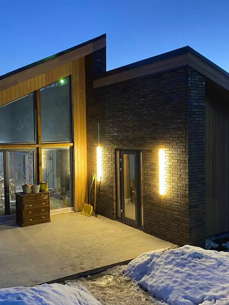 Modern minimalist black waterproof led wall light by decorbites with warm sconces on brick and wood house exterior